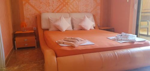 a bedroom with a bed with two towels on it at Apartmani Niksic in Herceg-Novi