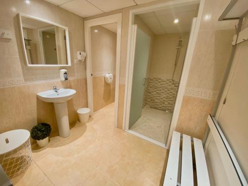 
a bathroom with a toilet, sink, tub and shower at Aparthotel SunClub Salou in Salou

