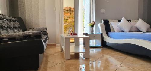 a living room with a couch and a table at Apartmani Niksic in Herceg-Novi