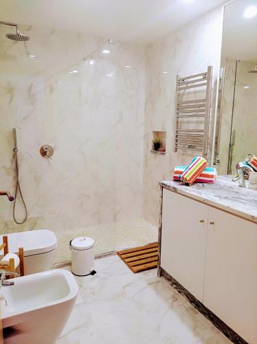 a bathroom with a sink and a toilet and a tub at Marina-G in Lagos