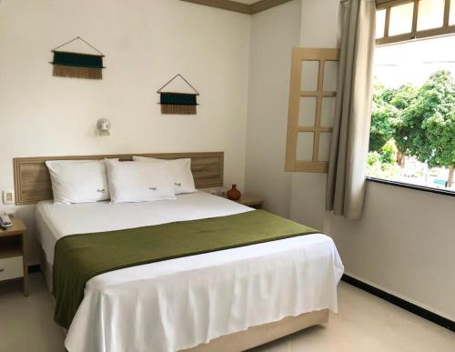 Un pat sau paturi într-o cameră la Pousada do Mingote