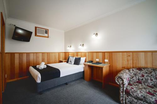 A bed or beds in a room at Best Westlander Motor Inn