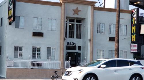 a white car parked in front of a building at Hollywood Stars Inn in Los Angeles