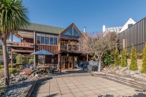 an exterior view of a house with a patio at Pointers - Akaroa Holiday Home in Akaroa