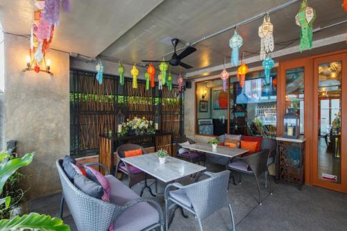 a restaurant with tables and chairs and colorful lights at Chala Number 2 Art and Gallery in Chiang Mai