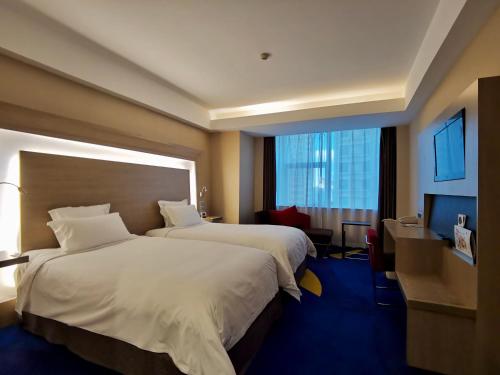 a hotel room with two beds and a large window at Shenzhen Novotel Watergate in Shenzhen