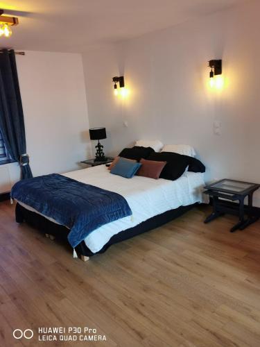 a bedroom with a large bed in a room at La Tour notre Dame in Boulogne-sur-Mer