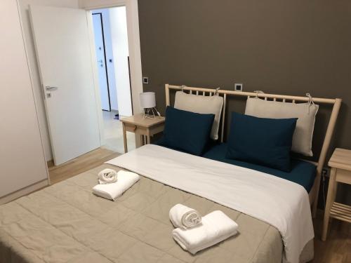 a bedroom with a large bed with towels on it at Apartman Linda in Cres