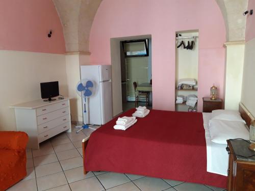 - une chambre avec un lit rouge et une couverture rouge dans l'établissement Centro Storico, à Brindisi