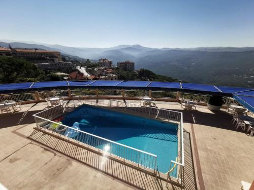 a large swimming pool on top of a building at Le Crillon in Broummana