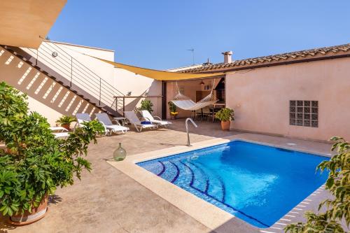 a swimming pool in the backyard of a house at Cas Padrins de ses Tanques in Ariany