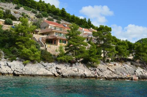 a house on a hill next to the water at Villa Zen in Prizba