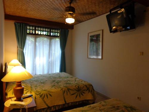 Postel nebo postele na pokoji v ubytování Klub Kokos Bungalows
