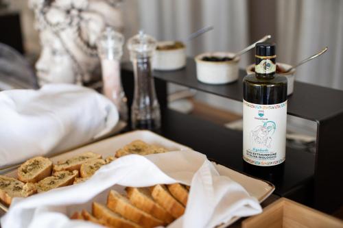a table with a bottle of oil and a tray of food at Relais Chiaramonte in Ragusa