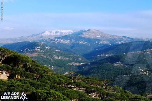 a view of a mountain range with snow capped mountains at Le Crillon in Broummana
