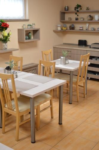 a dining room with two tables and chairs at Alfr&eacute;d Panzi&oacute; in Budapest