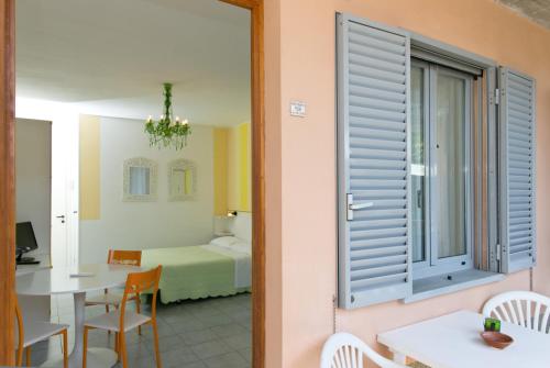 um quarto com uma cama, uma mesa e uma janela em Residence Castiglione em Castiglione del Lago