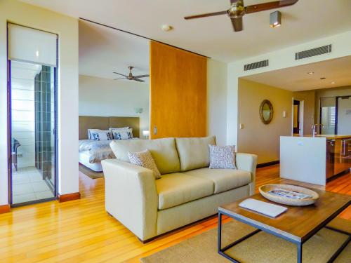 a living room with a couch and a table at Boathouse Port of Airlie in Airlie Beach
