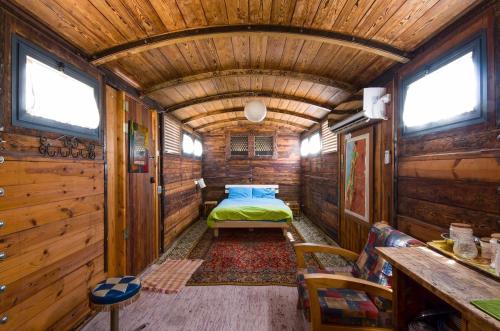 a bedroom in a wooden cabin with a bed in it at Galilee Bedouin Camplodge in Tabash