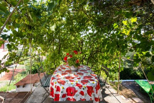 a table with a vase of flowers on it at Borgo Case Lucidi relax in Torano Nuovo