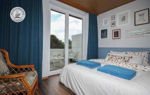 a bedroom with a bed and a large window at N&J GuestHouse Swan Bled in Bled