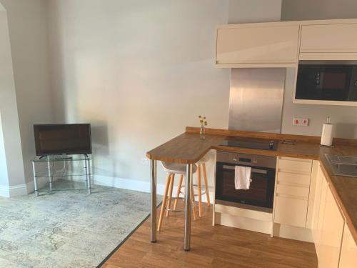 a kitchen with a counter and a stove top oven at 8 Aspland Road in Norwich
