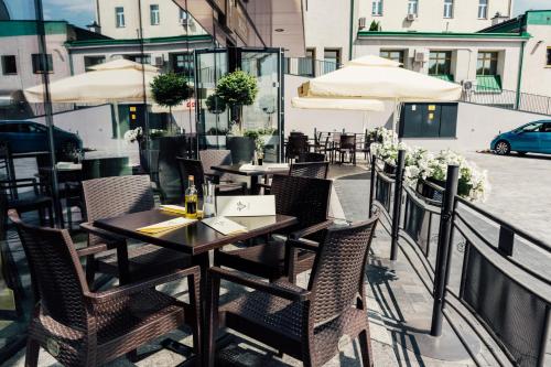 a restaurant with tables and chairs on a balcony at ibis Styles Lublin Stare Miasto in Lublin