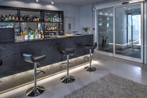 a bar with stools in front of a counter at Hotel Villa delle Fate, BW Signature Collection in Sestola