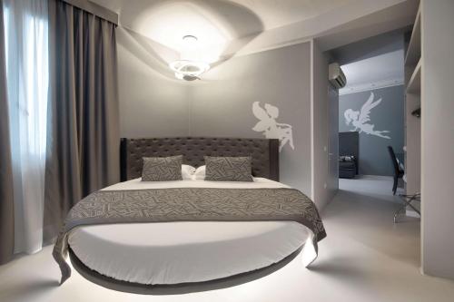 a bedroom with a large bed in a room at Hotel Villa delle Fate, BW Signature Collection in Sestola