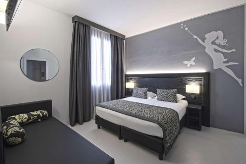a bedroom with a king sized bed and a mirror at Hotel Villa delle Fate, BW Signature Collection in Sestola
