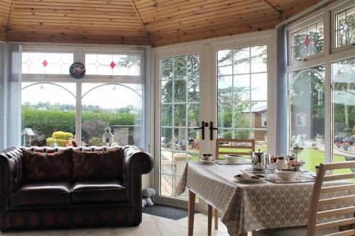 a living room with a table and a couch at The Meadows B&B in Armagh