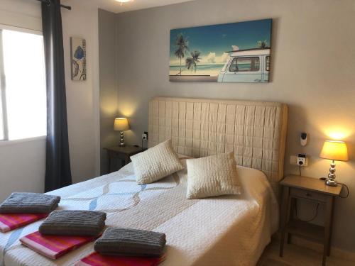 a bedroom with a bed with two pillows on it at Our Sol in Puerto de Mazarrón