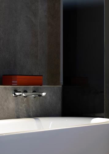 a bathroom with a sink and a mirror at Arthur Hotel Zhujiang New Town Guangzhou-Free Shuttle Bus to Exhibition Centre during Canton Fair in Guangzhou