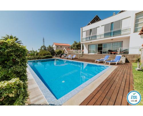 a swimming pool in the backyard of a house at Villa Sol by Amazing Madeira in Ponta do Sol