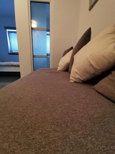a bedroom with a bed with two pillows on it at Goriška Apartments in Ajdovščina