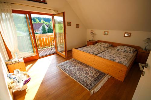 a bedroom with two beds and a balcony at Villa Katarina in Mokronog