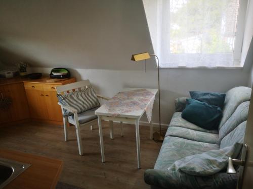 a living room with a table and a couch at Ferienwohnungen und Ferienhaus im Nixenweg in Hohwacht