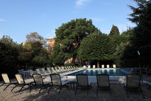 a group of chairs sitting next to a swimming pool at Grand Hotel Villa Balbi in Sestri Levante