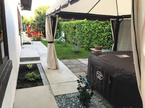 a bed under a tent in a garden at VECCHIA FAVOLA HOUSE in Quarto dʼAltino