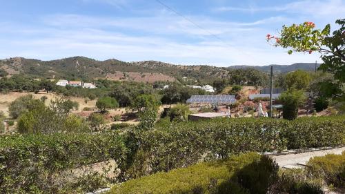 a view of a farm with a solarium and mountains at Alagoas Park in Loulé