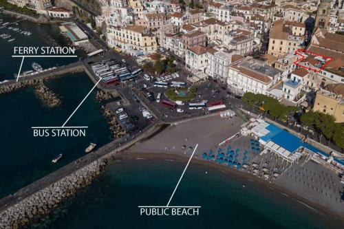 an aerial view of a beach with buildings and the ocean at Mamma Rosanna - Apartment in Amalfi with terrace in Amalfi