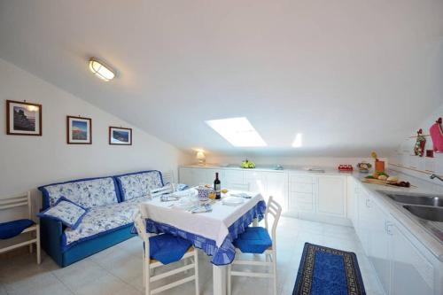 a kitchen with a table and a couch in a room at Mamma Rosanna - Apartment in Amalfi with terrace in Amalfi