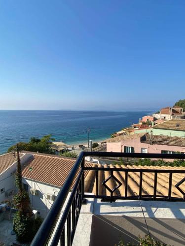 a view of the ocean from a balcony at Beach villa Aetos kaminaki Nissaki in Nisakion