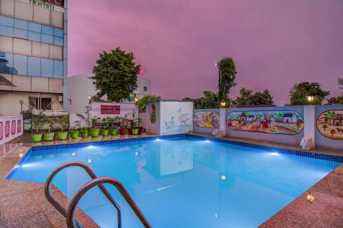 a swimming pool in a hotel at night at FabHotel Himanshi in Udaipur