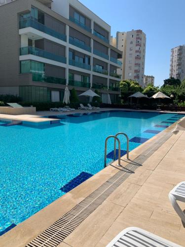 a large swimming pool in front of a building at Antalya Residence by Lara in Antalya