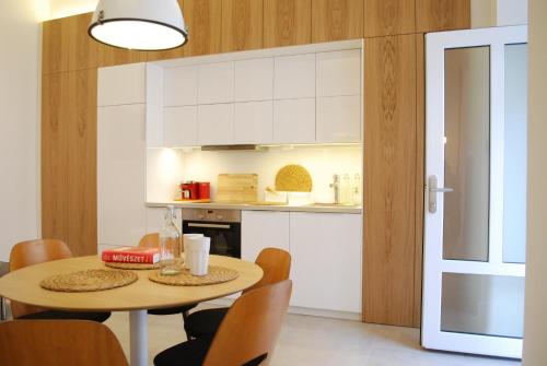 a kitchen and dining room with a table and chairs at Stylish Studios Apartment in the City Center with Air Conditioning in Budapest