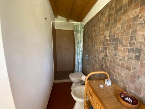 a bathroom with two toilets and a sink at Karrua House - Magnolia Room in Modica