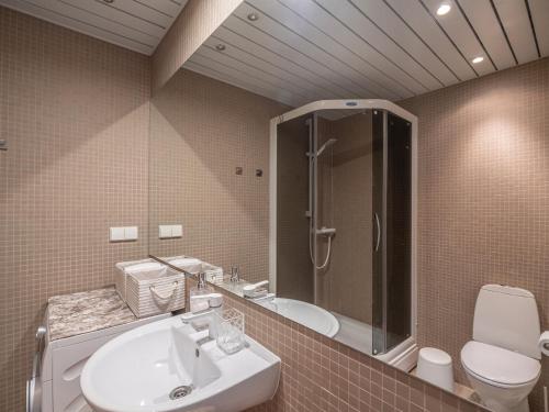 a bathroom with a sink and a shower and a toilet at Pärnu Ranna Residents in Pärnu