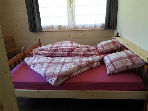 a bed with two pillows on top of it at Ferien in der Bergwelt von Adelboden in Adelboden