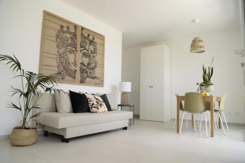 a living room with a couch and a table at Cocciu d’amuri in Terrasini